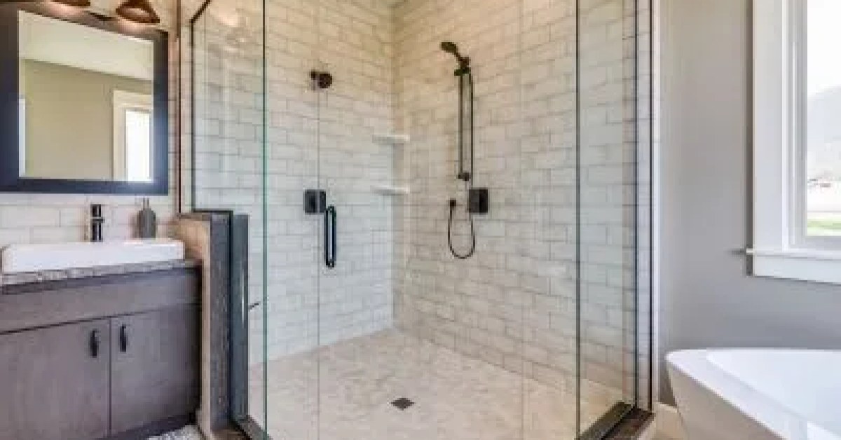 Newly installed shower with glass enclosure and tiled walls